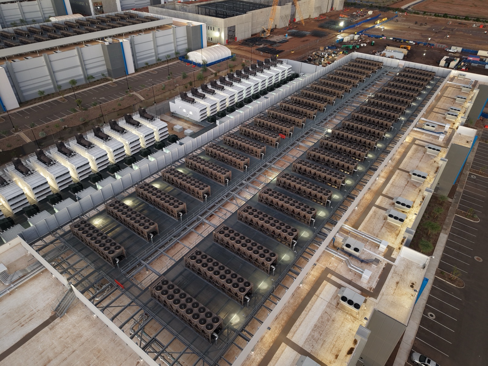 An aerial view of a data centre roof with cooling towers and backup generators