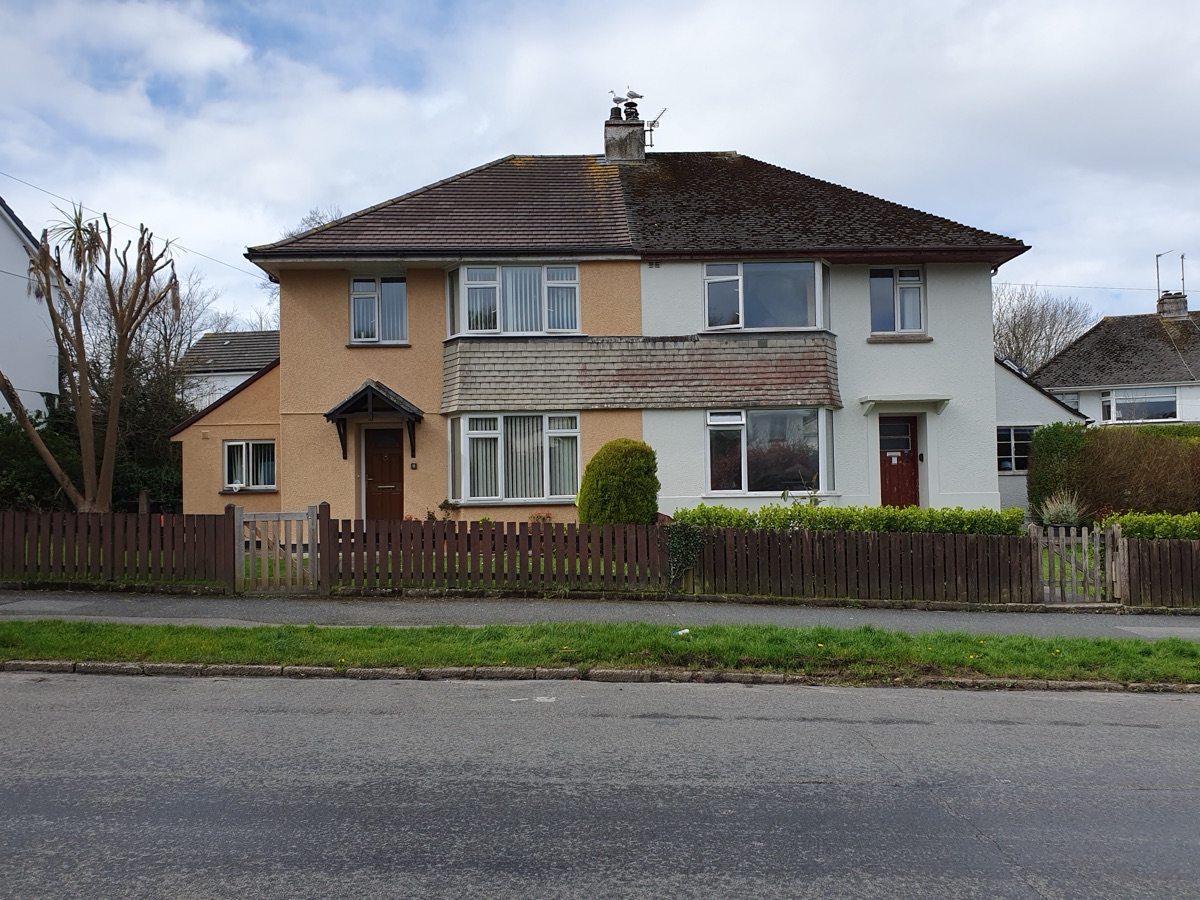 A semi-detached family home with a driveway and garden